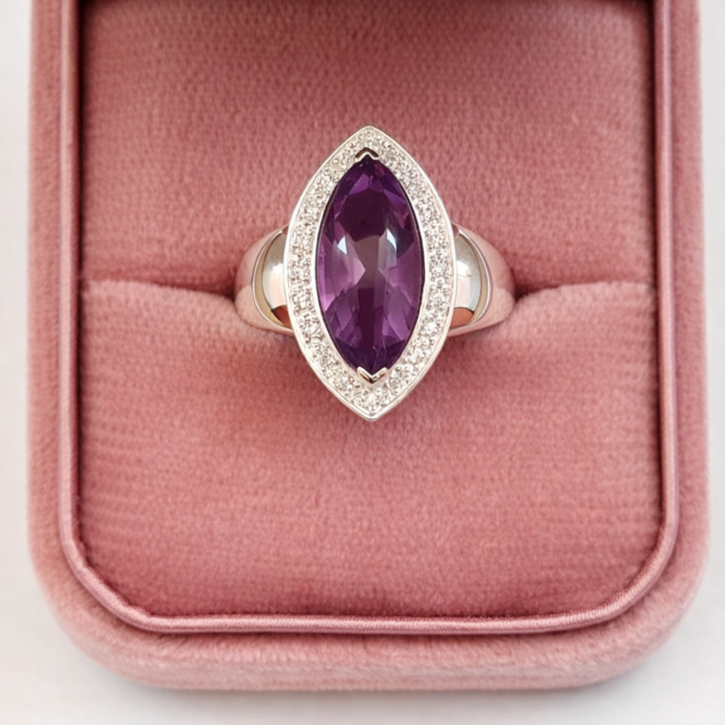 Ring with a purple gemstone on a pink cushion