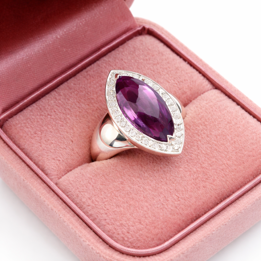 Sterling Silver ring with a purple gemstone on a pink cushion