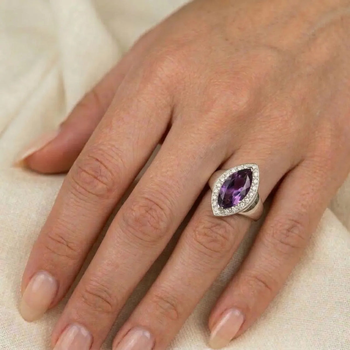 Marquise amethyst sterling silver ring worn on a finger