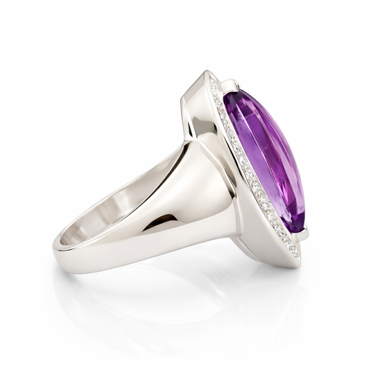 Silver ring with a purple gemstone on a white background