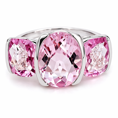 Silver ring with three pink gemstones on a white background